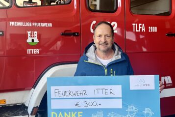 Ein Vertreter der Feuerwehr Itter bei der Scheckübergabe.